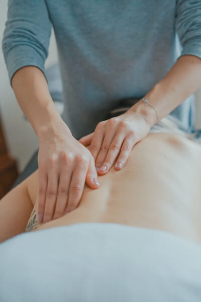 Massage therapist performing a relaxing back massage in a spa setting